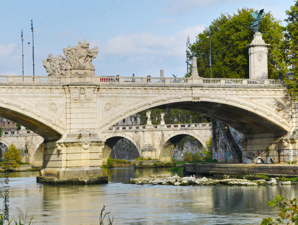 Bridges crossing the Tiber river in Rome Italy on a fall day.
