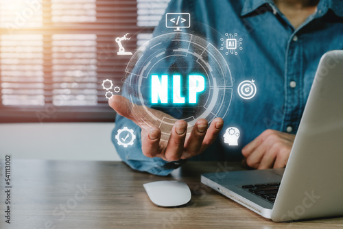 NLP natural language processing cognitive computing technology concept, Business person hand holding VR screen NLP icon on office desk, AI Artificial intelligence. photo
