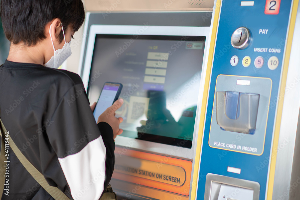 Teen boy buy ticket for train transportation Teen boy buy ticket for train transportation
