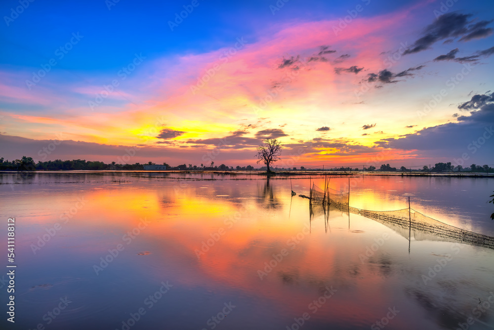 Sunset along the river flooded swampy countryside as the sun down horizon really dramatic end of a sunny day.