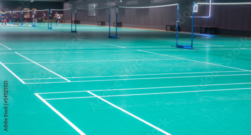 Many people playing badminton indoor
