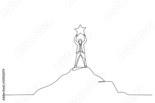 businessman standing at top of hill and touching bright star from the sky