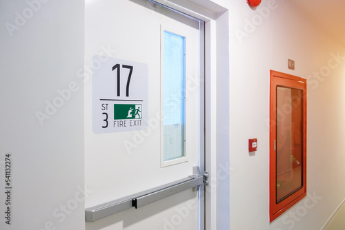 Photography Fire extinguisher system on the wall with Fire Exit door sign for emergency