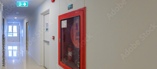 Canvas Print Fire extinguisher system on the wall with Fire Exit door sign for emergency