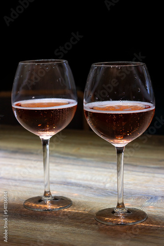 two glasses of champagne close-up on a dark background