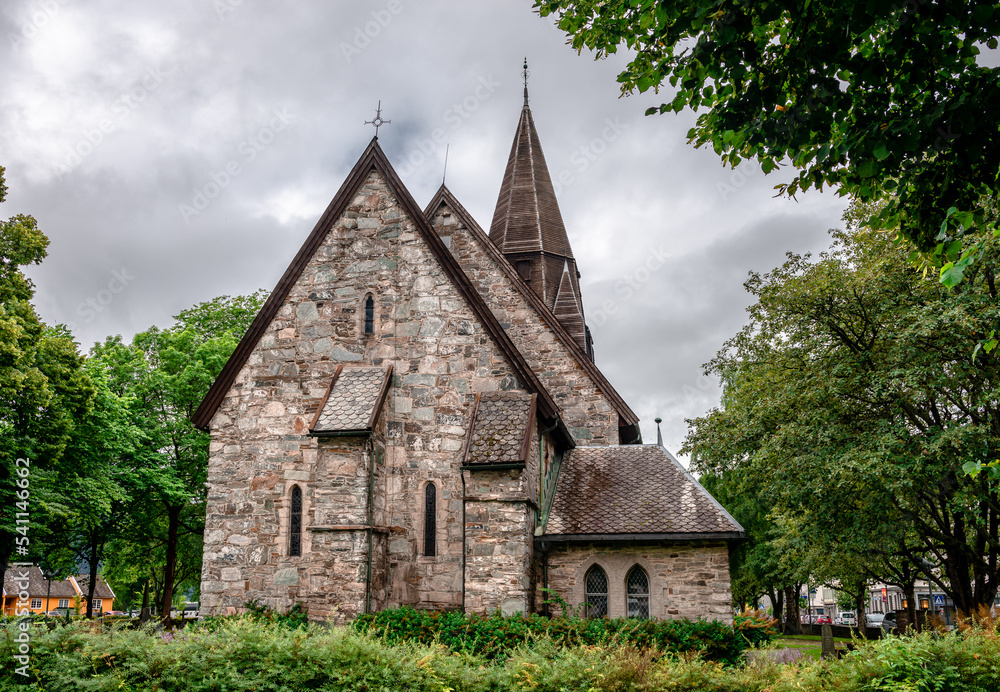 Voss Church in the village of Vossevangen (or Voss), in Vestland County, Norway. This gray, stone church was built in a long church design in 1277. Voss Church in the village of Vossevangen (or Voss), in Vestland County, Norway. This gray, stone church was built in a long church design in 1277.