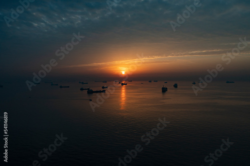 sunrise over the sea and waiting ships