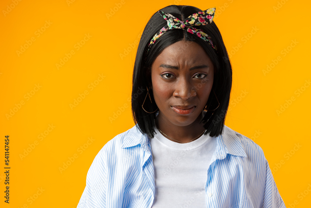 Young african woman on a yellow background confused, feels doubtful and unsure Young african woman on a yellow background confused, feels doubtful and unsure
