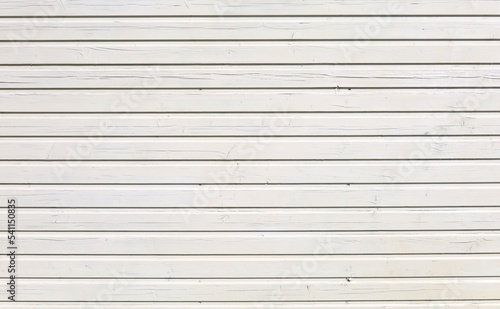 White painted wood paneling with horizontal strips under the sunlight. Background and texture, copy space.