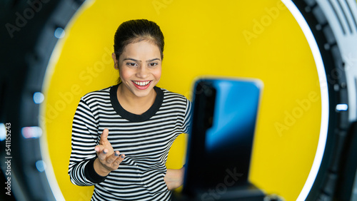 Photography Beautiful young Asian vlogger or blogger making video with ring light and smartphone