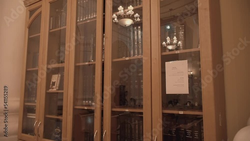 Modern Jewish library in Synagogue. Bookshelves with volumes. Traditional books in Judaic library: Torah, Talmud. Historic building of Jewish community. House of Jewish Spirituality and Divine Law.