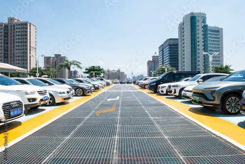  Outdoor parking lot with modern buildings and sky background.