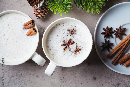 Print op canvas Homemade chai latte with cinnamon and star anise in white cup, dark background