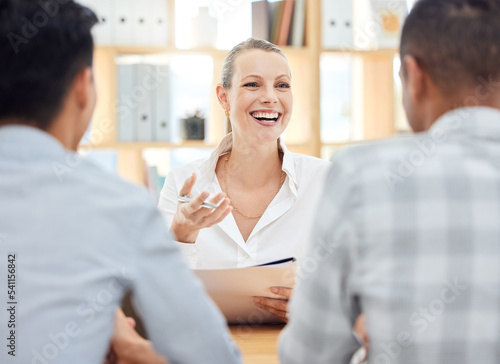 Planning, strategy and manager in a meeting, working and talking to employees about a report on company growth at work. Happy, smile and young boss in communication with workers on corporate budget