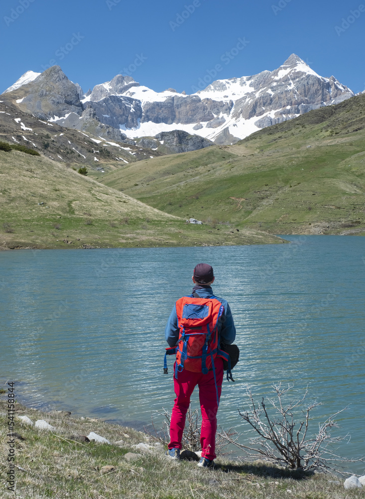 Hiker looking at the landscape in the Ibon Escarra Tena Valley, Huesca.
