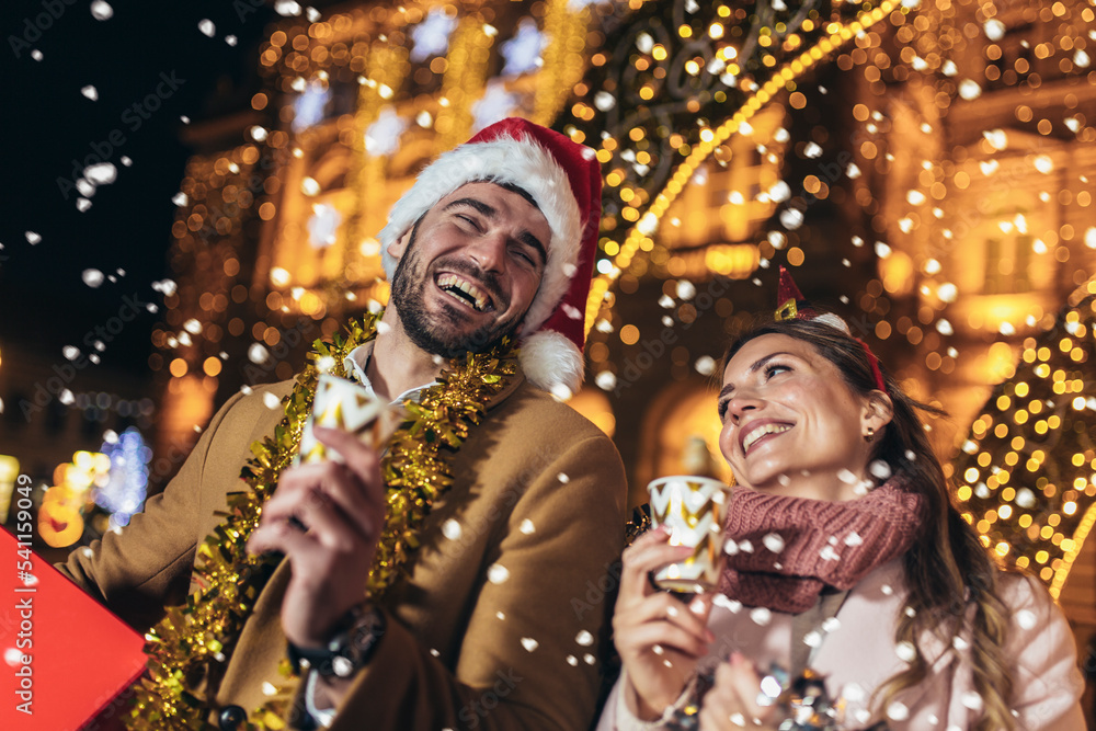 Young romantic couple is having fun outdoors in winter before Christmas. Young romantic couple is having fun outdoors in winter before Christmas.