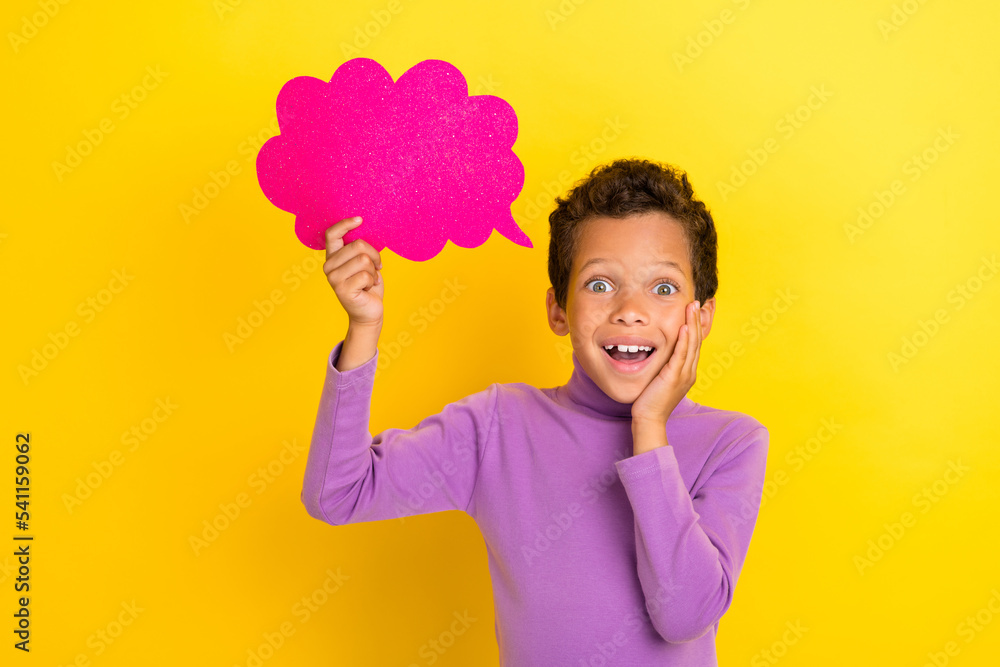 Portrait of astonished little person arm touch cheek hold empty space cloud shape card isolated on yellow color background Portrait of astonished little person arm touch cheek hold empty space cloud shape card isolated on yellow color background
