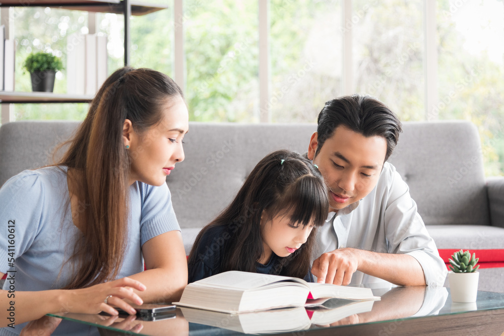 Happy family sitting together and help teaching daughter about her homework in living room. Happy family sitting together and help teaching daughter about her homework in living room.