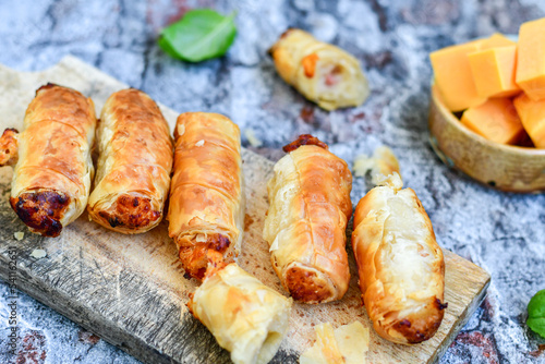  Greek style Mini filo pastry rolls with bacon and cheddar cheese .Home made bakery .Fresh baked Mini cheese ,meat and herbs puff pastries