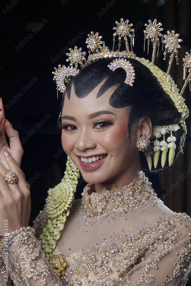 Beautiful model, wearing makeup and Javanese Indonesian wedding dress.