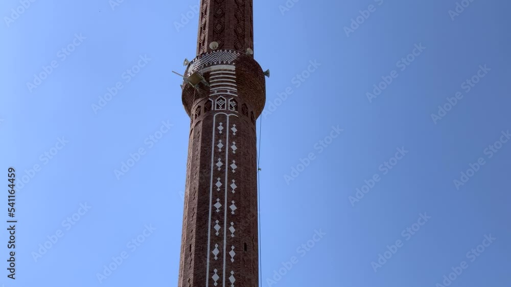 finishing the minaret of a mosque in Yemen against a blue sky. 4K video. islam. finishing the minaret of a mosque in Yemen against a blue sky. 4K video. islam.