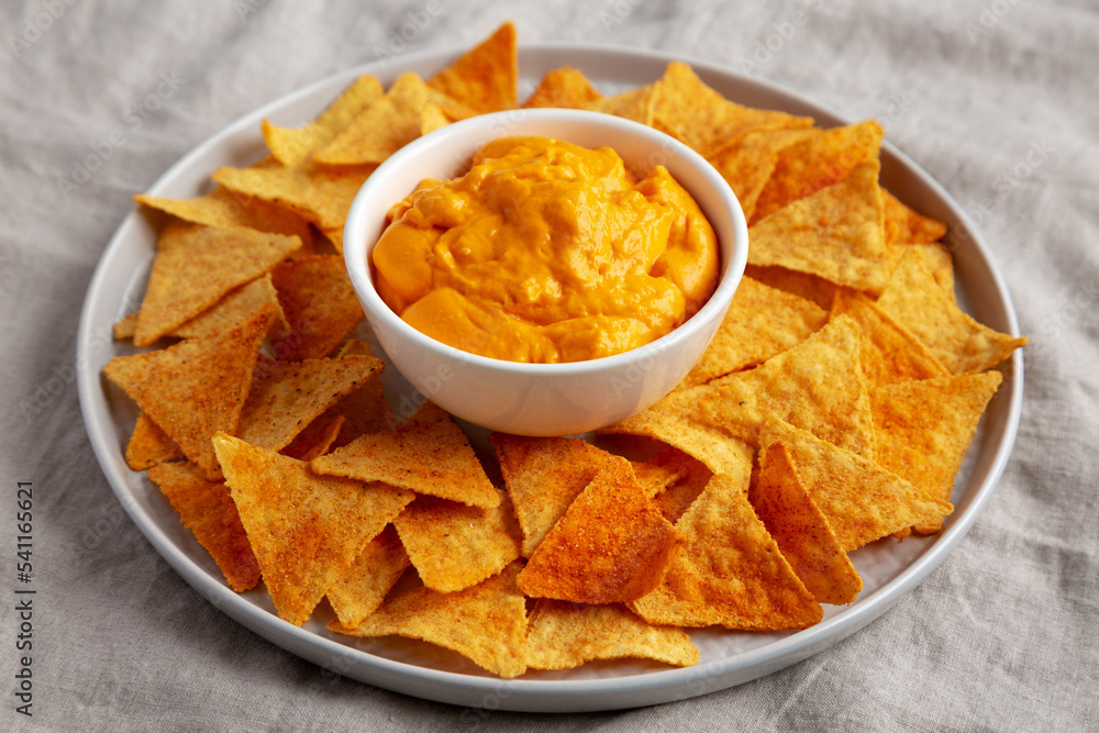 Cheese dip with tortilla chips, low angle view. Cheese dip with tortilla chips, low angle view.