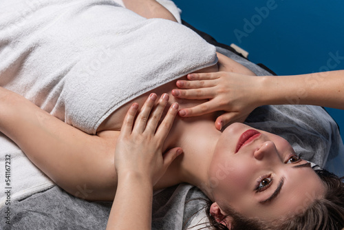 Face and decollete  massage with oil in the spa office photo