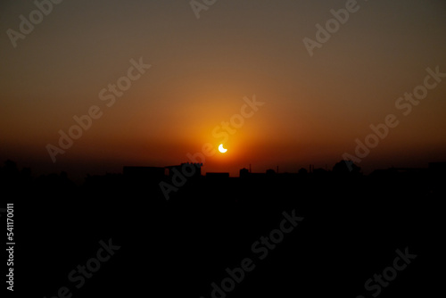October 25th 2022 Dehradun City  Uttarakhand India. Partial Solar Eclipse in th evening with cityscape.