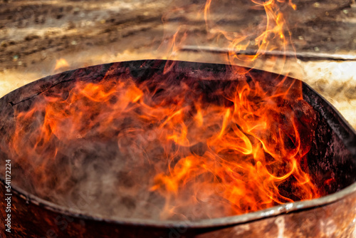 Burning fire in a barrel close-up. Bright flame. Open flame heating. Problems with heating and gas.