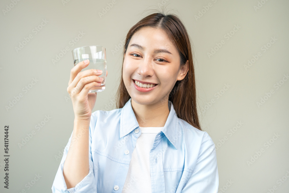 Happy beautiful, hand of asian young woman drinking, sip fresh glass of water for hydration of body, holding transparent glass in her hand, thirsty at home. Health care, healthy lifestyle concept. Happy beautiful, hand of asian young woman drinking, sip fresh glass of water for hydration of body, holding transparent glass in her hand, thirsty at home. Health care, healthy lifestyle concept.