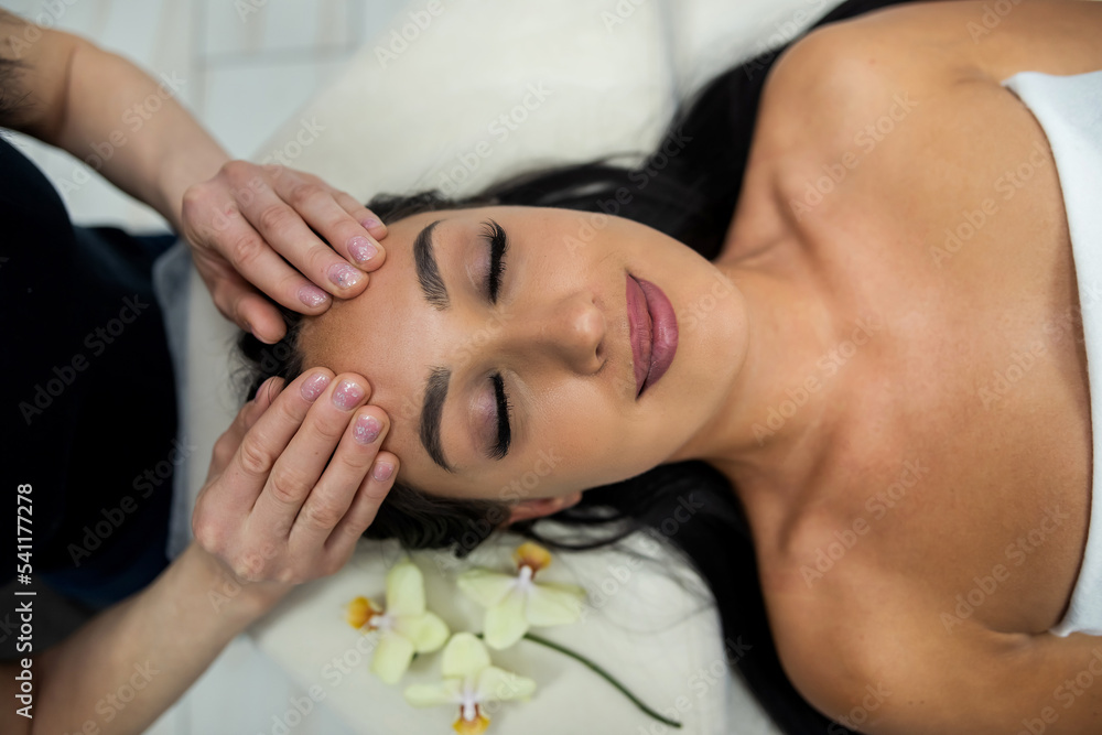 close up of beautician hands doing relaxing rejuvenating massage female client at spa salon close up of beautician hands doing relaxing rejuvenating massage female client at spa salon