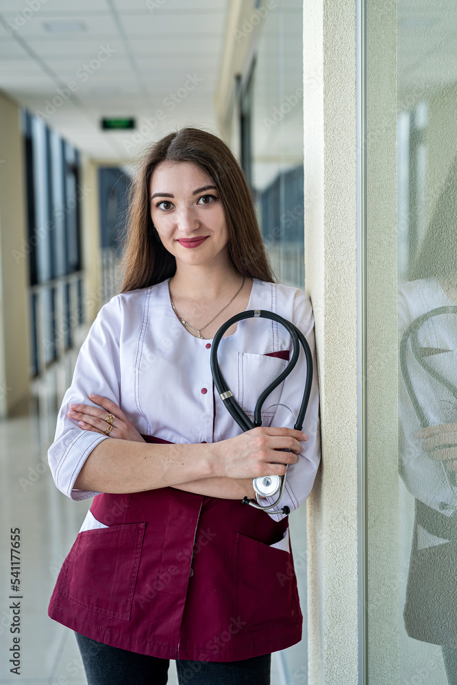Portrait of a young attractive smiling nurse in uniform