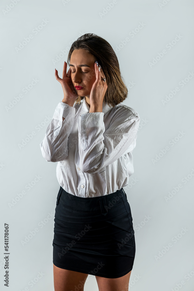 Beautiful young brunette suffering from headache on white isolated background. Beautiful young brunette suffering from headache on white isolated background.