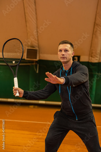 male tennis player on the court looks happy doing his hobby.