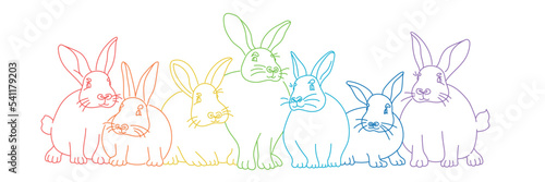 Seven colored rabbits sit together.