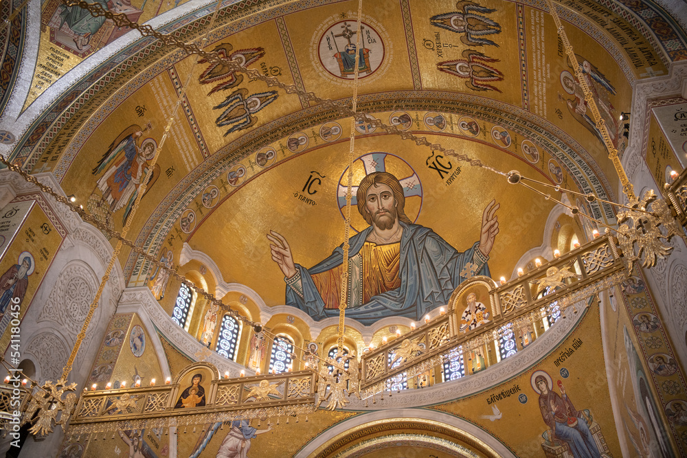Interiors of St. Sava's Church in Belgrade with religious paintings and mosaics on the luxuriously gold decorated walls. Belgrade, Serbia 22.09.2022