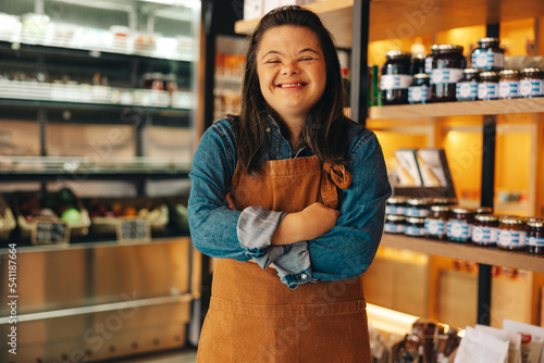 Shop worker with Down syndrome smiling at the camera photo
