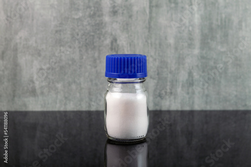 Calcium chloride, salt with chemical formula CaCl2. Food additive E509. White powder used as an electrolyte in sports drinks and other beverages, including bottled water photo