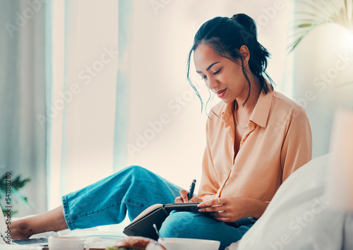 Black woman, notebook and writing for planning, notes and happy student in bed, comfortable and thinking. Creative girl, happiness and artist with idea, notepad or creating list for budget in bedroom
