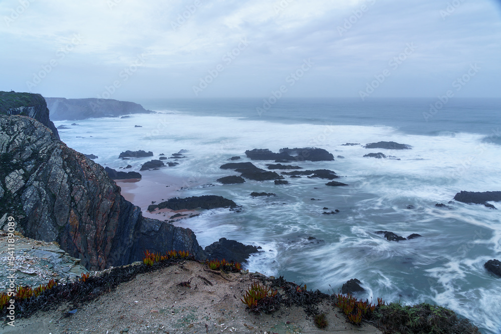 clifftop view looking over a dusk ocean horizon