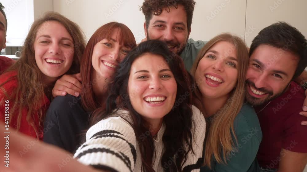 girl holds camera and poses while her mates have fun making funny faces and gestures. Selfie camera POV girl holds camera and poses while her mates have fun making funny faces and gestures. Selfie camera POV
