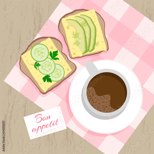 Cheese, cucumber and avocado toasts, a cup of coffee and a card with a wish for bon appetit on a checkered napkin