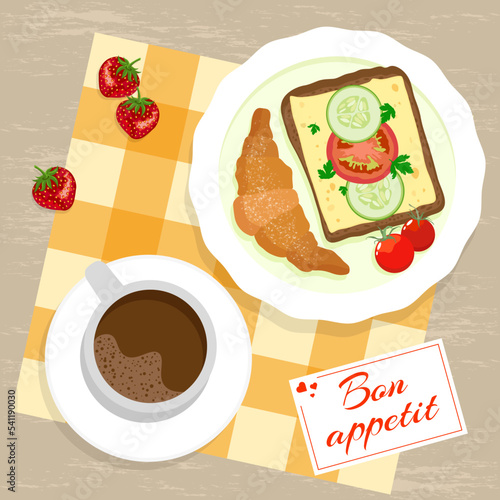 Appetizing breakfast with cup of coffee, cheese sandwich, croissant and strawberries on checkered napkin and bon appetit card
