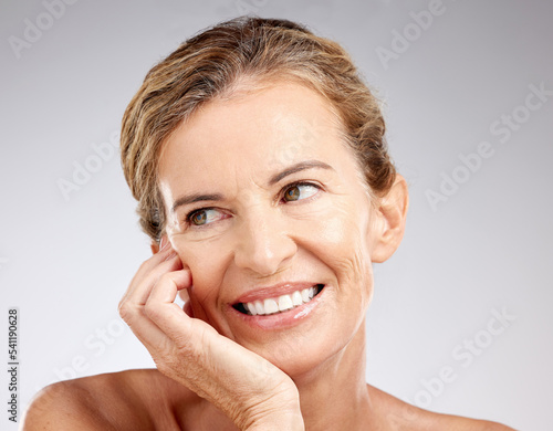 Skincare, senior woman and with smile being confident, natural beauty and wrinkles in studio background. Elderly female, mature lady and happiness for body care, happy and face glow being proud.