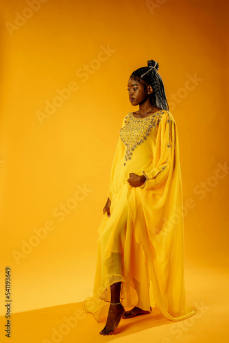 a girl in a yellow dress on a yellow backgrou