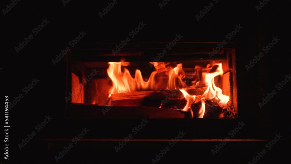 Roaring fire in a woodstove fireplace. Yellow and orange flames. Slow motion Roaring fire in a woodstove fireplace. Yellow and orange flames. Slow motion