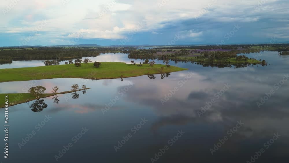 Aerial view of a calm lake at sunset reflecting clouds and atmosphere Aerial view of a calm lake at sunset reflecting clouds and atmosphere