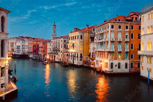 View of Venice's Grand Canal at sunset with illuminated historic buildings and light trails of tourist boats © Jan Cattaneo