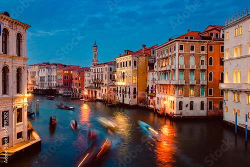 View of Venice's Grand Canal at sunset with illuminated historic buildings and light trails of tourist boats © Jan Cattaneo