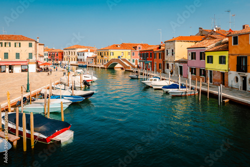 Typical Murano canal with colorful houses and moored boats
